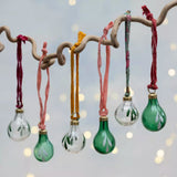 Set of six clear and green glass Christmas baubles with hand-painted botanical leaves