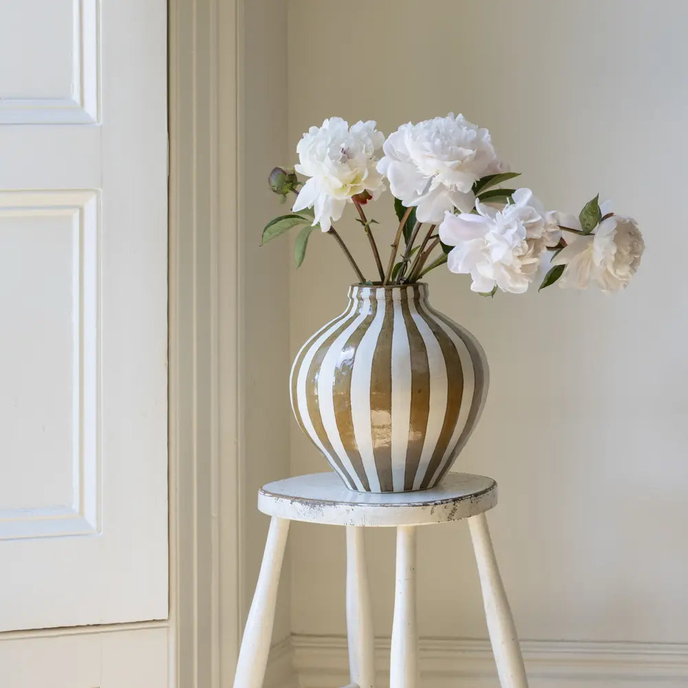 Bulbous decorative vase with warm camel vertical stripes and rounded sculptural shape
