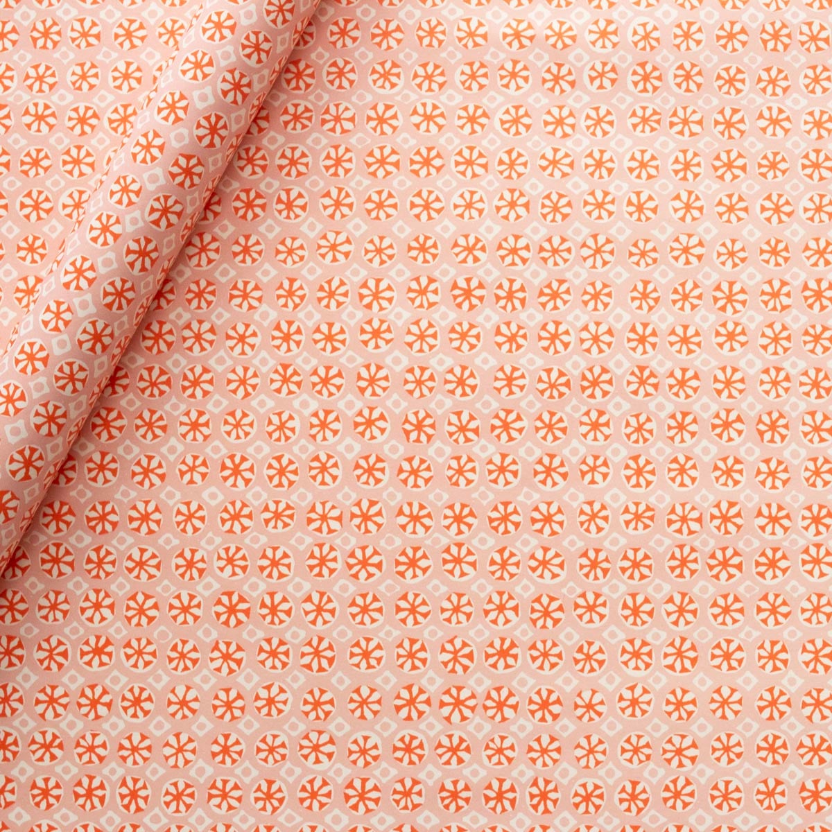 Cambridge Imprint Sea Urchin Neon Orange wrapping paper with a delicate repeating pattern, printed in England on premium matte paper.