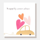 Wedding congratulations card featuring an illustrated wedding car with floating hearts and the words Happily Ever After, finished with gold foil and embossing.