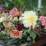 Natural hand-tied seasonal funeral sheaf with garden-style flowers and fresh foliage, handcrafted by Mad Lilies florists in Banstead, Surrey.