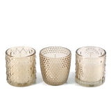 Elegant champagne glass votive with white unscented candle. Perfect for weddings, table styling, and home décor. Approx. 15hr burn time.