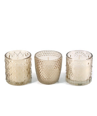 Elegant champagne glass votive with white unscented candle. Perfect for weddings, table styling, and home décor. Approx. 15hr burn time.