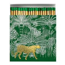 Luxury Cheetah matchbox featuring a gold foil cheetah walking through a green jungle-inspired design and containing 125 matches.