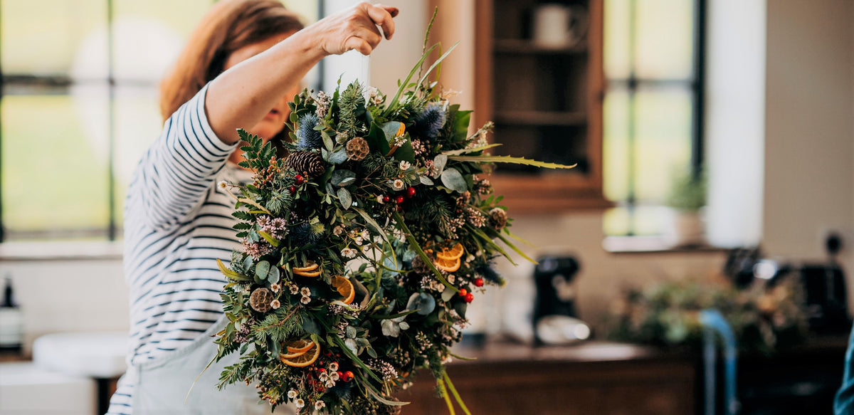 Luxury fresh Christmas door wreath handmade with spruce, eucalyptus and seasonal foliage by Mad Lilies in Surrey