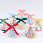 Liberty floral print party hats from the Meri Meri x Liberty collaboration with velvet ribbon bows and ricrac edging.