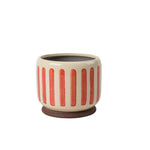 Coral crackle glaze stoneware plant pot with subtle striped texture and integrated stand for displaying indoor houseplants.