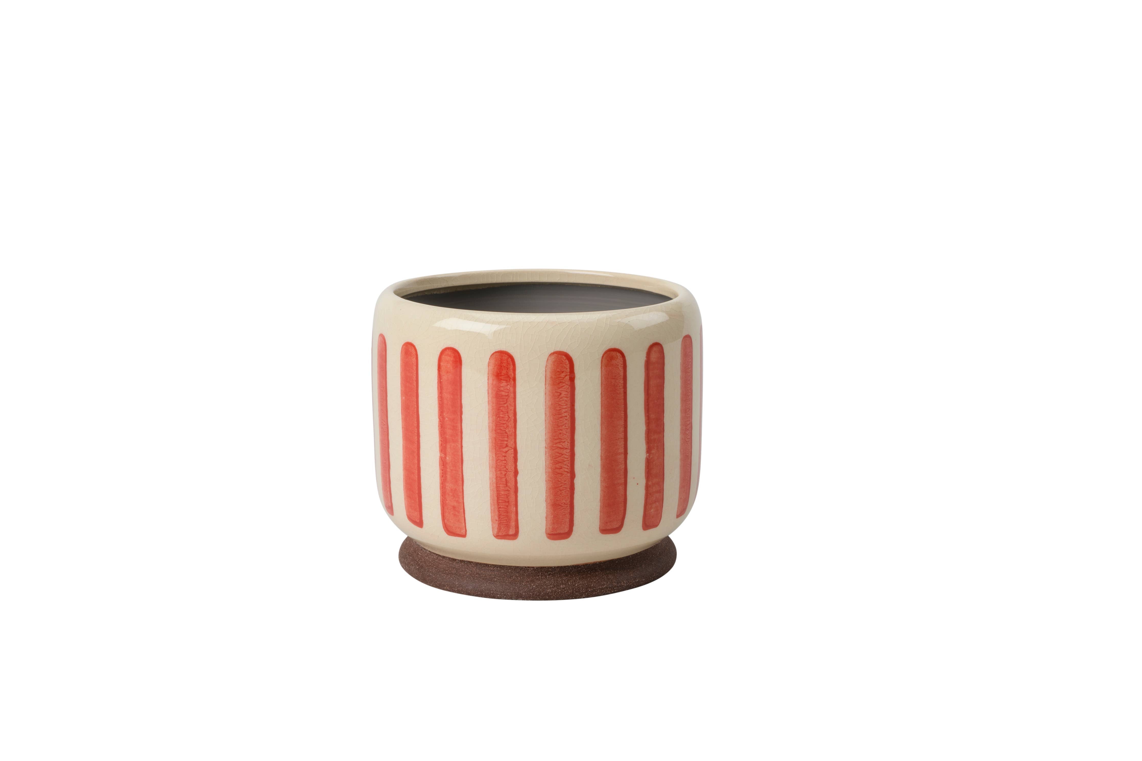 Coral crackle glaze stoneware plant pot with subtle striped texture and integrated stand for displaying indoor houseplants.