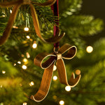 Shop three Cromwell Christmas Bow Decorations in antique brass, finished with berry velvet hangers. Perfect for Christmas trees, garlands and wreaths.