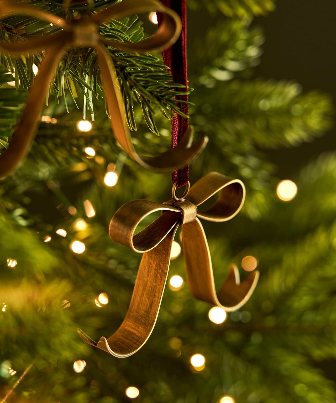Shop three Cromwell Christmas Bow Decorations in antique brass, finished with berry velvet hangers. Perfect for Christmas trees, garlands and wreaths.