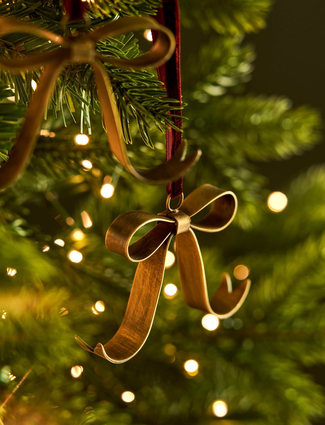 Shop three Cromwell Christmas Bow Decorations in antique brass, finished with berry velvet hangers. Perfect for Christmas trees, garlands and wreaths.