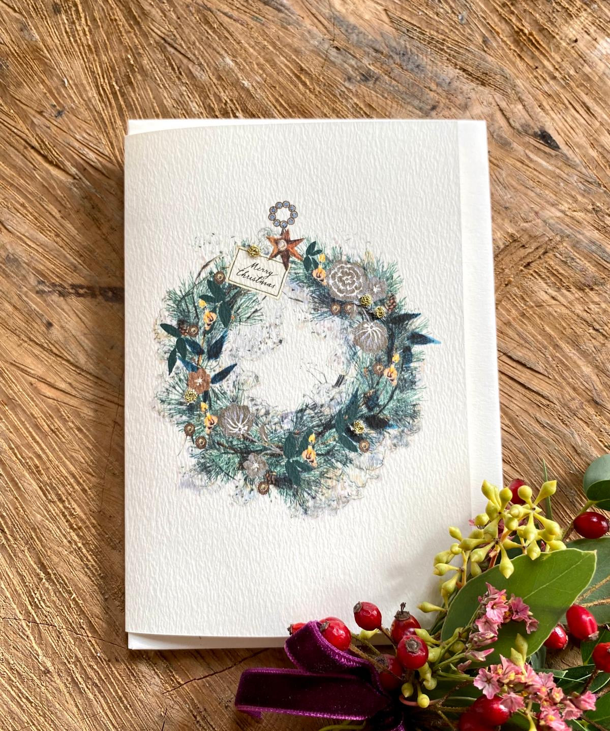 Handmade Candlelit Garland Christmas card featuring original artwork by Elena Deshmukh, individually hand stitched on premium textured cardstock.