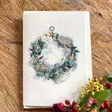 Handmade Candlelit Garland Christmas card featuring original artwork by Elena Deshmukh, individually hand stitched on premium textured cardstock.