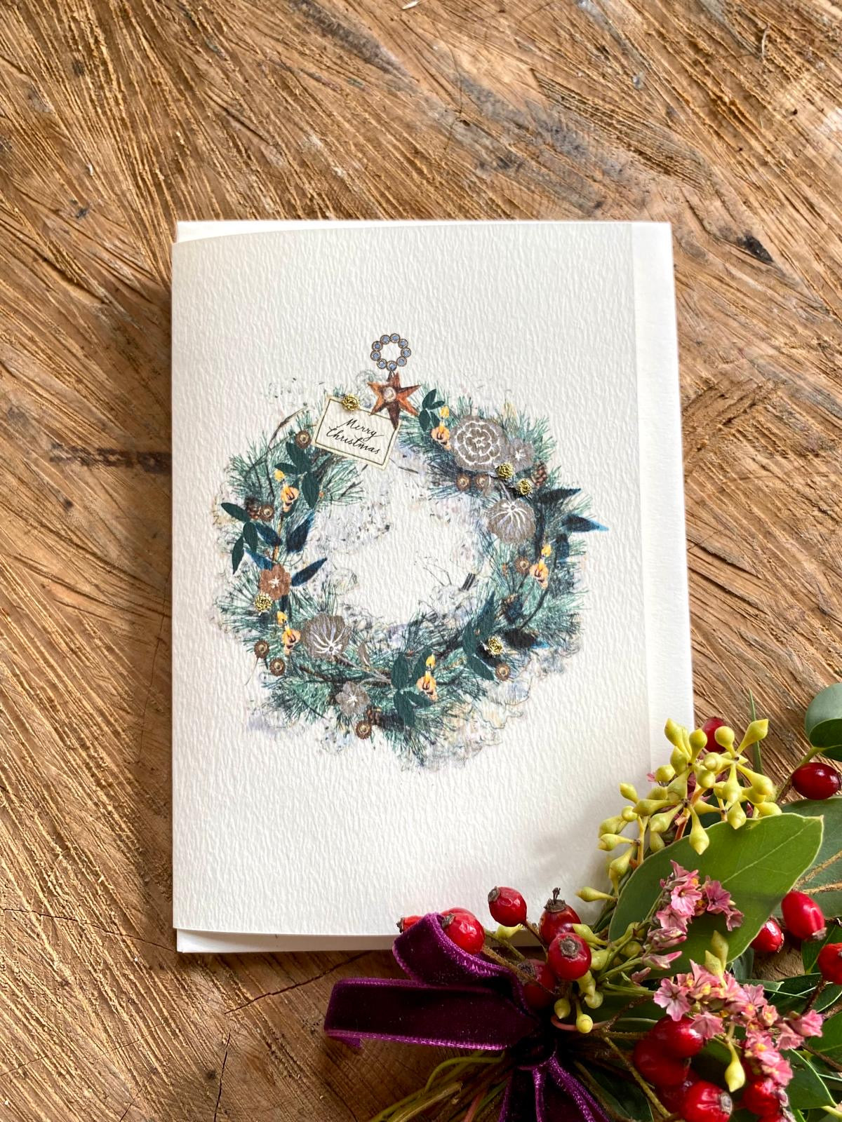 Handmade Candlelit Garland Christmas card featuring original artwork by Elena Deshmukh, individually hand stitched on premium textured cardstock.