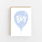 It's a Boy greeting card featuring a pastel blue balloon with hand-lettered calligraphy on luxury textured cardstock.