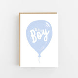 It's a Boy greeting card featuring a pastel blue balloon with hand-lettered calligraphy on luxury textured cardstock.