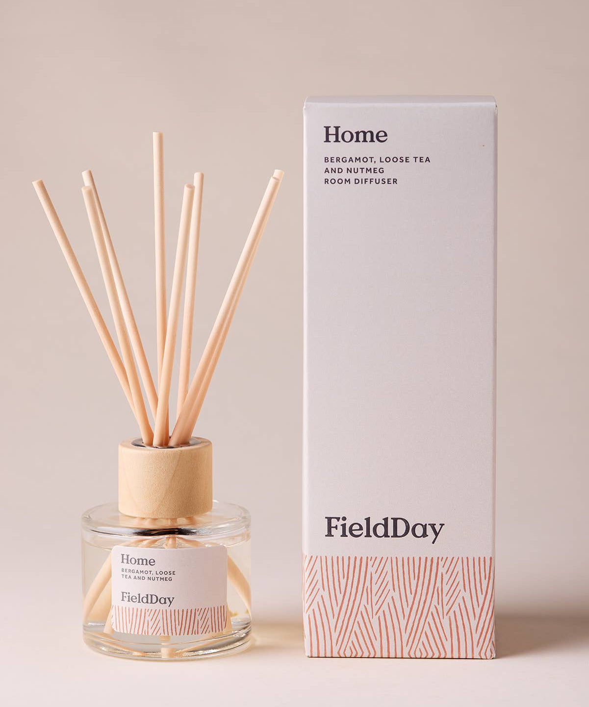 FieldDay Home reed diffuser with bergamot, loose tea and nutmeg in a glass bottle with wooden cap and natural reeds.