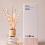 FieldDay Home reed diffuser with bergamot, loose tea and nutmeg in a glass bottle with wooden cap and natural reeds.