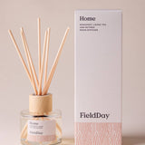 FieldDay Home reed diffuser with bergamot, loose tea and nutmeg in a glass bottle with wooden cap and natural reeds.