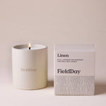 FieldDay Linen scented candle in a reusable stoneware pot with fresh flax, lavender and rosemary fragrance.