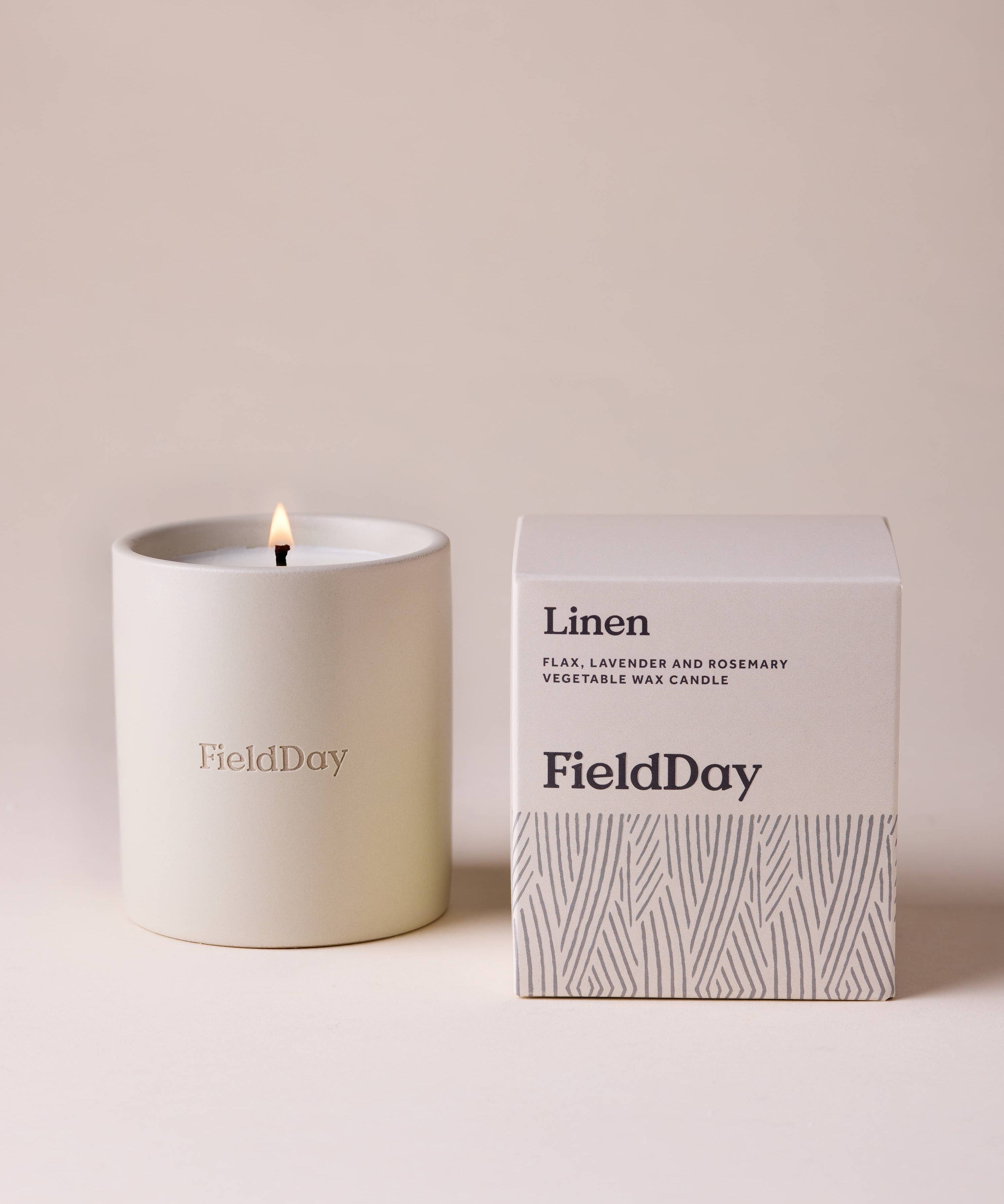 FieldDay Linen scented candle in a reusable stoneware pot with fresh flax, lavender and rosemary fragrance.