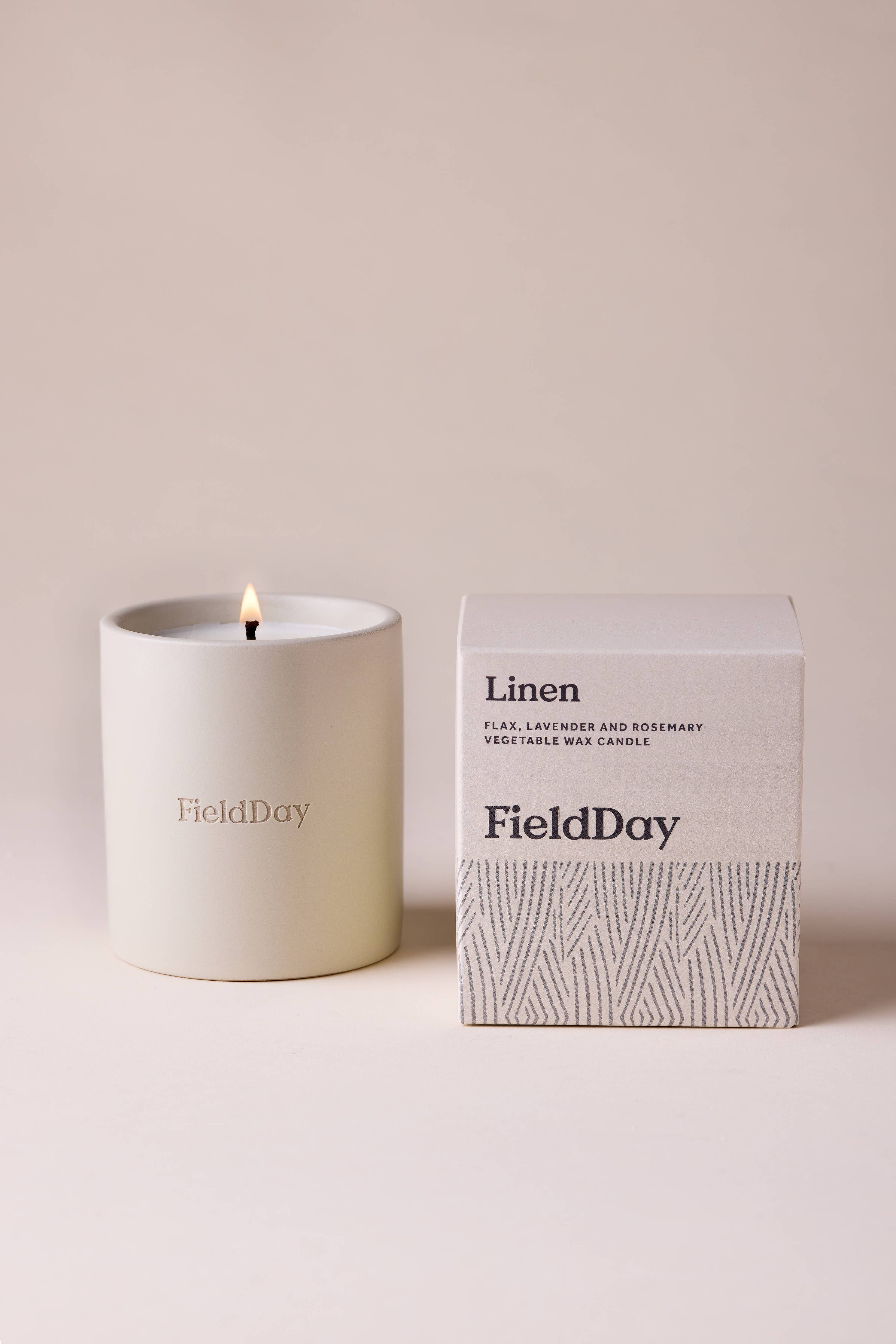 FieldDay Linen scented candle in a reusable stoneware pot with fresh flax, lavender and rosemary fragrance.