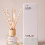 FieldDay Sea reed diffuser with salt air, lemon and sandalwood in a glass bottle with wooden cap and natural reeds.