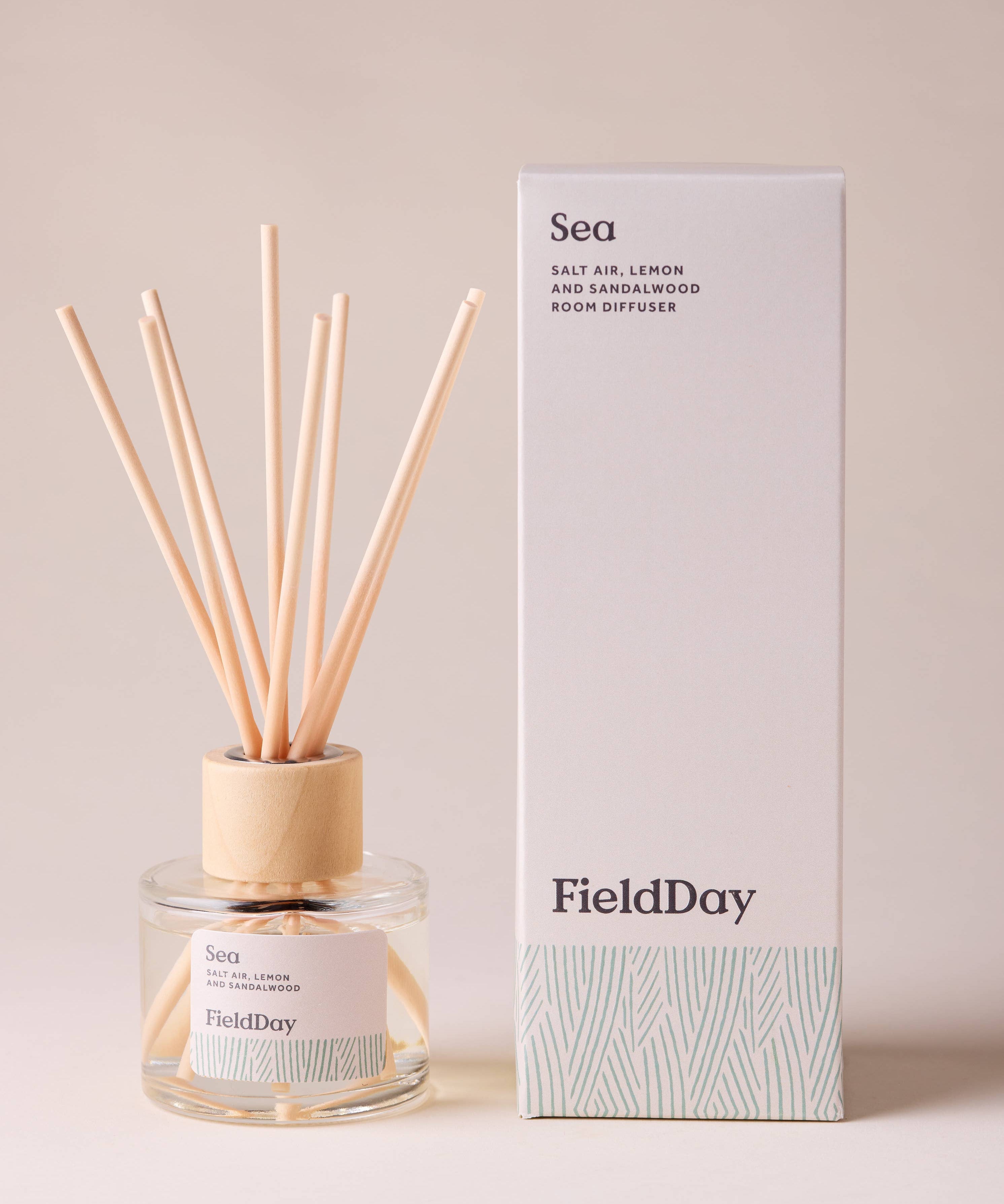 FieldDay Sea reed diffuser with salt air, lemon and sandalwood in a glass bottle with wooden cap and natural reeds.