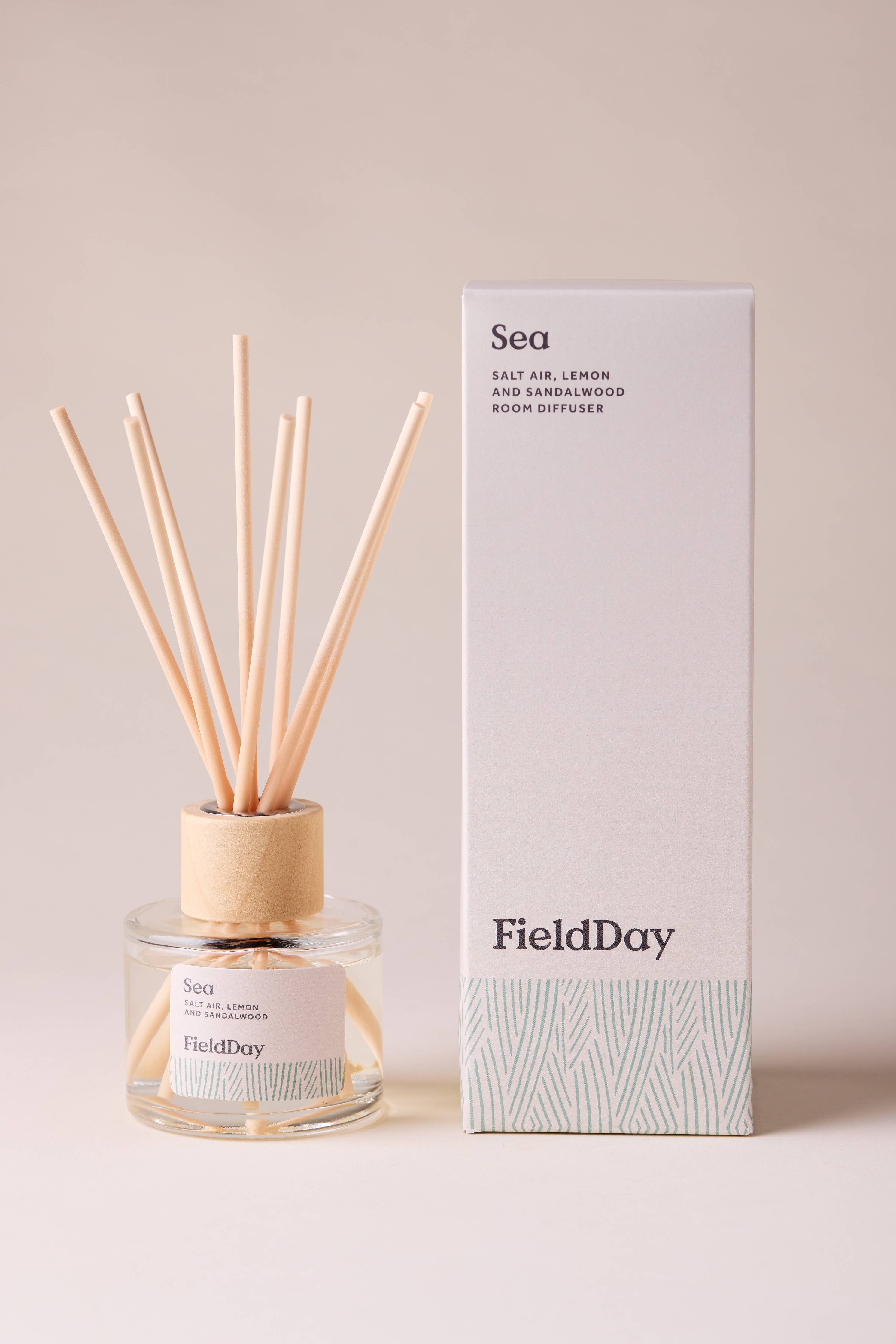 FieldDay Sea reed diffuser with salt air, lemon and sandalwood in a glass bottle with wooden cap and natural reeds.