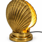 Gold Shell Table Lamp featuring a sculptural shell design and warm ambient lighting for stylish interiors.