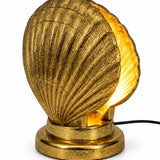 Gold Shell Table Lamp featuring a sculptural shell design and warm ambient lighting for stylish interiors.