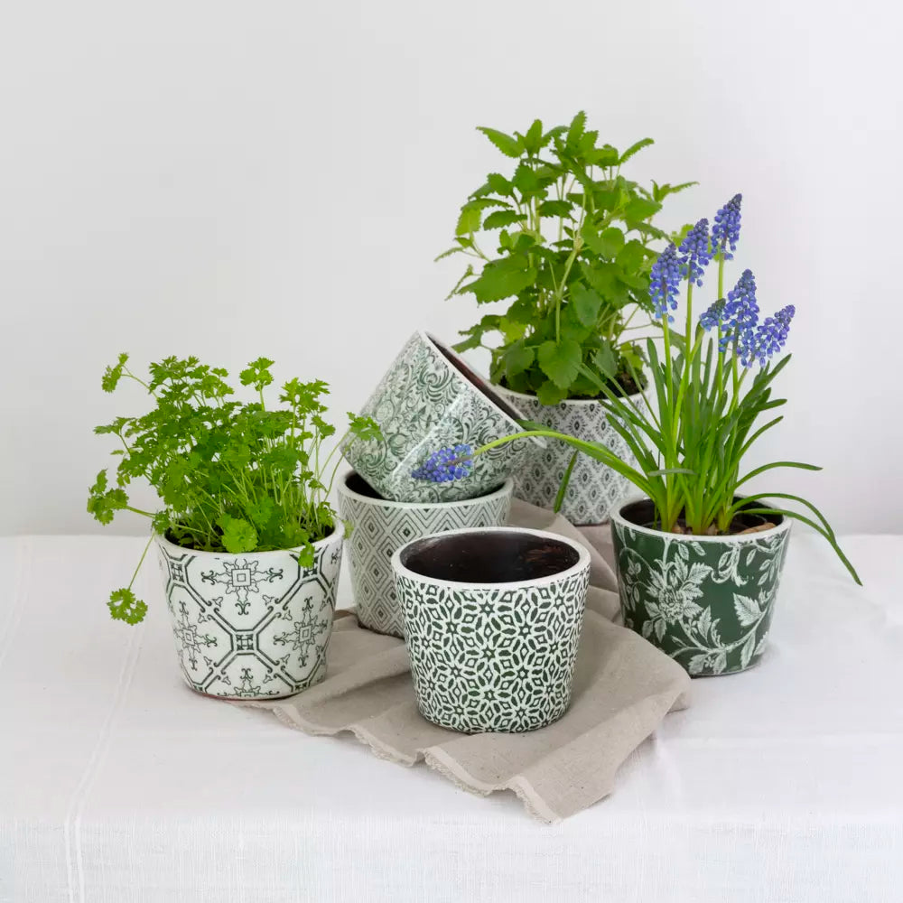 Handcrafted green glazed terracotta plant pots with vintage and modern designs. Perfect for indoor and outdoor plants.