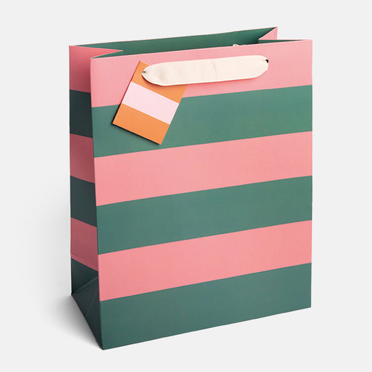 Large green and pink striped gift bag made from thick matt card with fabric handles and a matching gift tag.