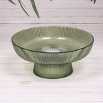 Shop green ridged glass pedestal bowl. A 20cm decorative serving dish perfect for fruit, desserts and elegant table styling.