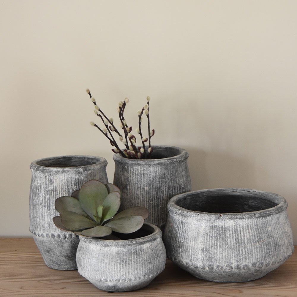 Rustic grey wash ribbed planters with a weathered finish. Decorative indoor plant pots perfect for trailing plants, houseplants and contemporary interiors.