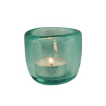 Hand-blown coloured glass tealight holder available in blue, green and orange, creating a warm jewel-like glow when illuminated with a tealight candle.