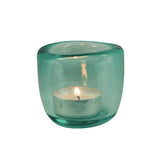 Hand-blown coloured glass tealight holder available in blue, green and orange, creating a warm jewel-like glow when illuminated with a tealight candle.