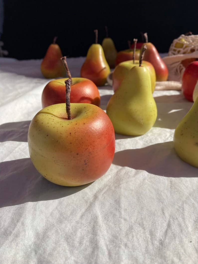 Hand-painted apple-shaped soy wax candle with realistic detailing, individually finished by hand.