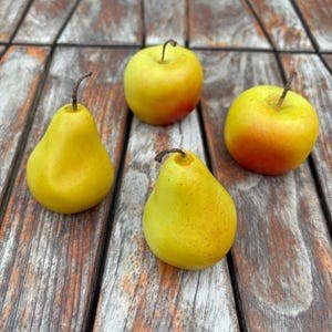 Small hand-painted pear-shaped candle handmade from 100% soy wax with realistic detailing.