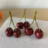 Handmade cherry-shaped candle crafted from 100% natural beeswax