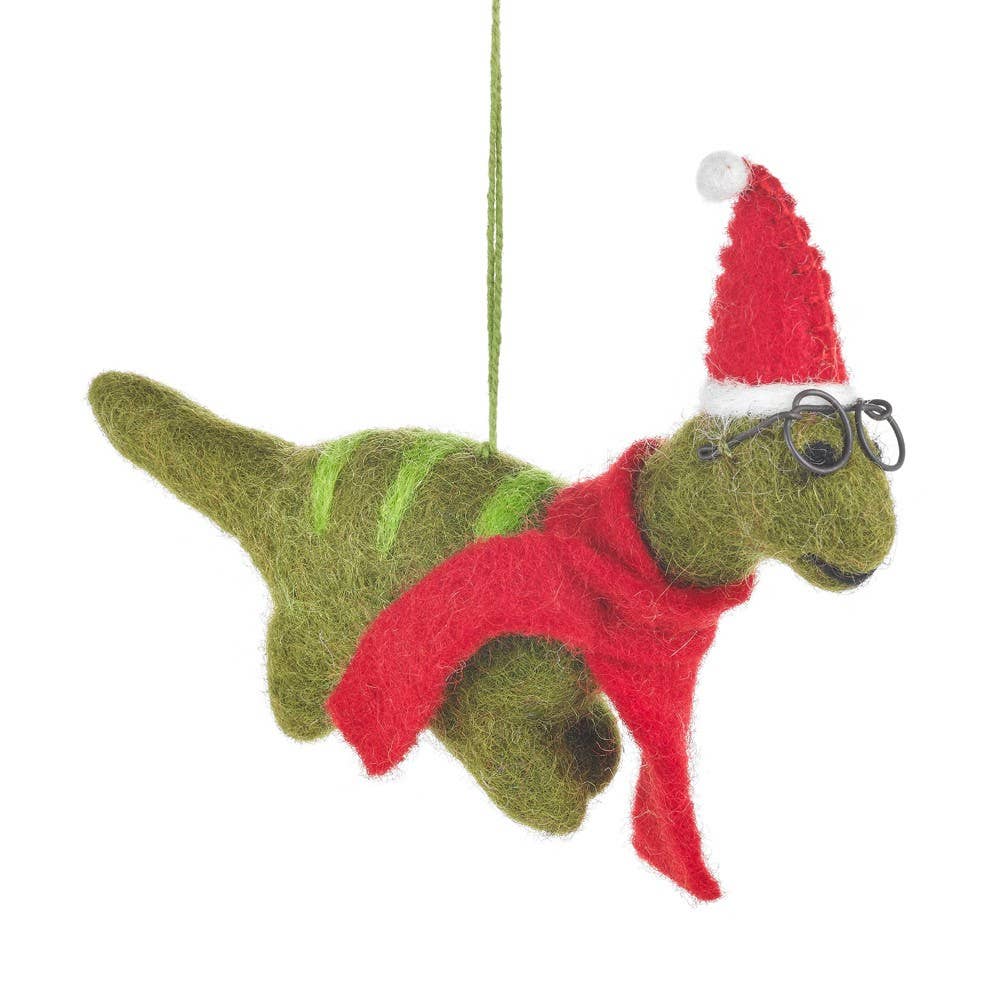 Handmade felt dinosaur Christmas tree decoration wearing glasses, a festive hat and scarf.