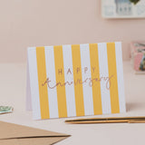 Happy Anniversary yellow stripe greetings card with gold foil lettering.