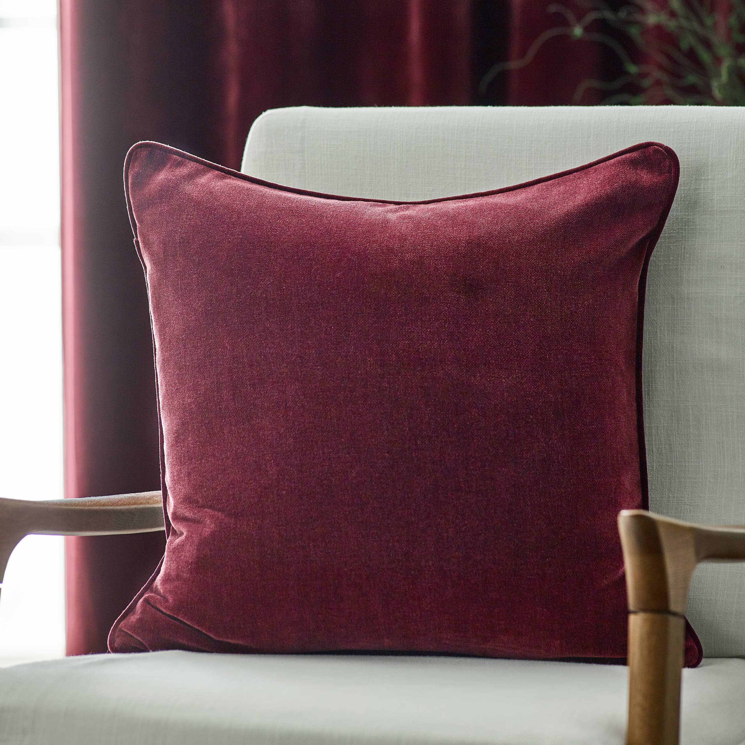 Heavy chenille piped cushion in rich mulberry burgundy colour, 50cm square