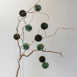 Emerald and mint honeycomb paper garland with gold edging and warm LED fairy lights