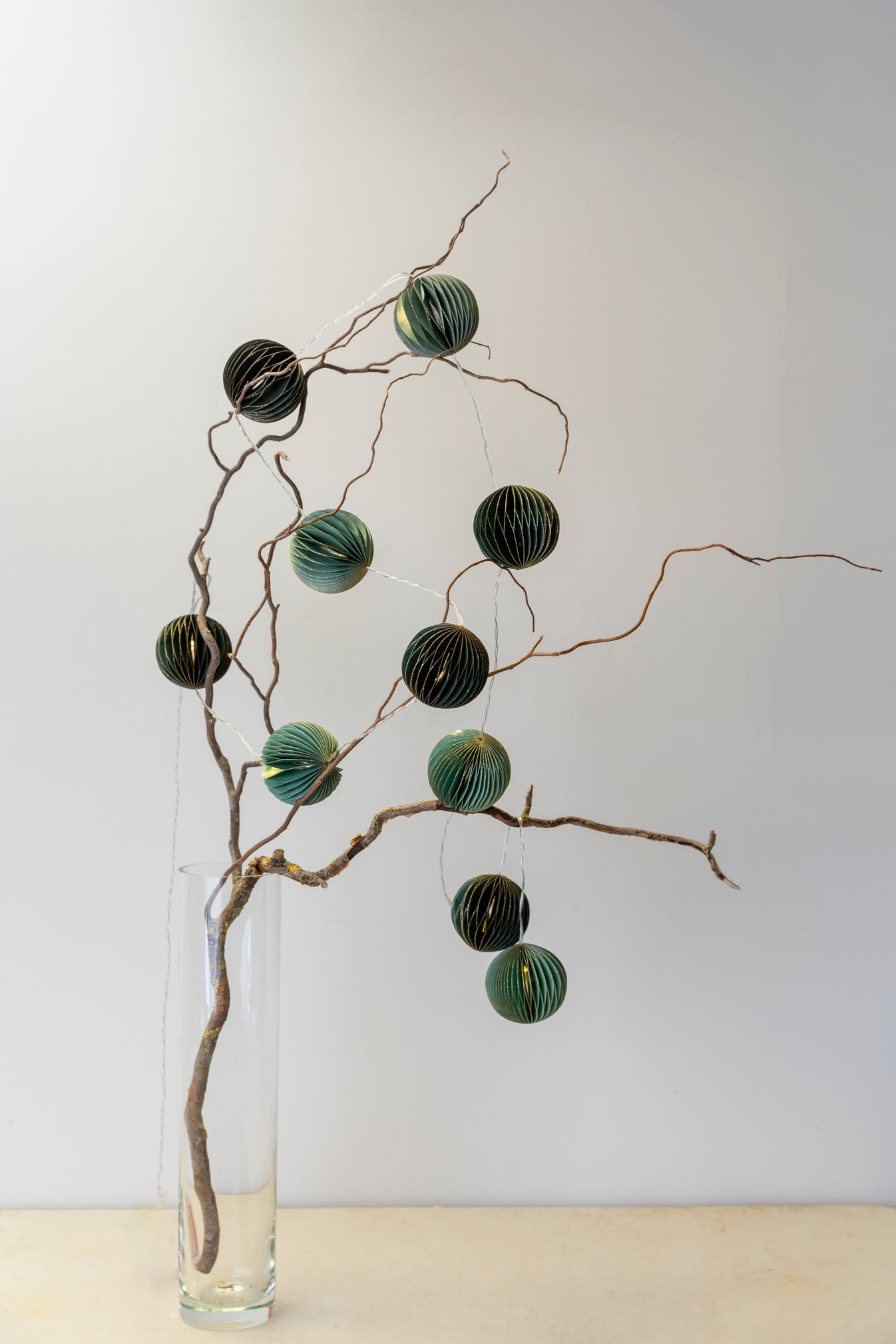 Emerald and mint honeycomb paper garland with gold edging and warm LED fairy lights
