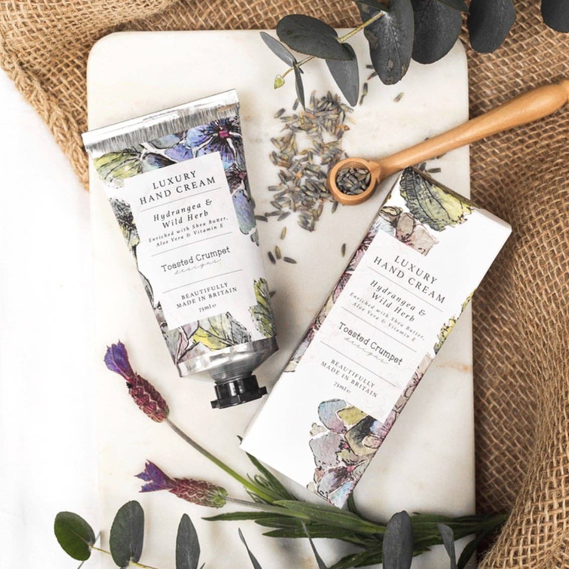Hydrangea & Wild Herb luxury hand cream by Toasted Crumpet. Nourishes and softens skin with a fresh, countryside-inspired fragrance. Beautifully boxed and made in Britain.