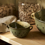 Ithaca Berry Bowl in Moss green stoneware with perforated sides and handles for rinsing and serving fresh fruit.