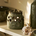 Moss green stoneware garlic storage pot with lid and ventilation holes
