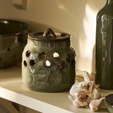 Moss green stoneware garlic storage pot with lid and ventilation holes