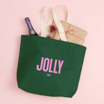 Jolly Tired Christmas tote bag in forest green cotton canvas with bold pink lettering, sturdy handles and a spacious flat base